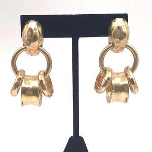 Brushed gold tone somewhat brutalist slightly hammered post dangle earrings